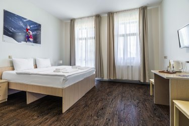 A room with a balcony in a three-room suite with a shared bathroom, building A